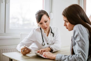 Female doctor consulting with a woman about her health