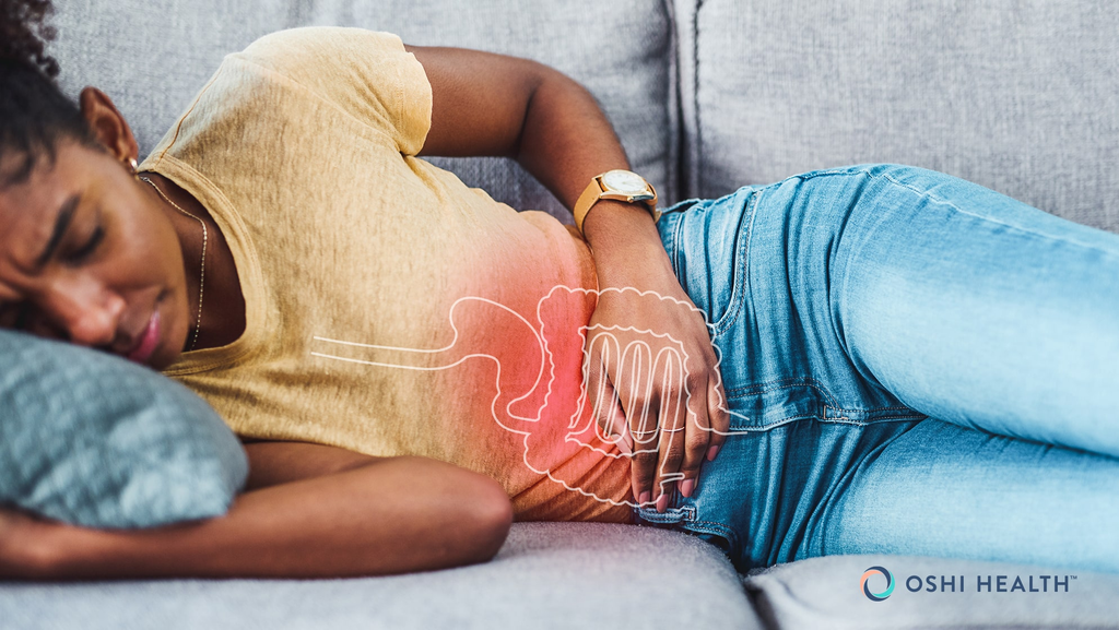 Woman lying on a couch with digestive pain