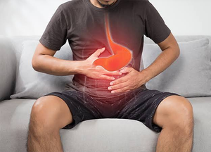 Man holding his stomach with digestive discomfort