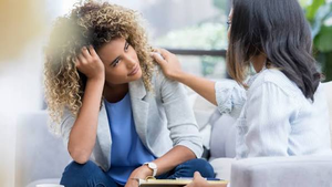 Stressed woman talking with a mental health professional