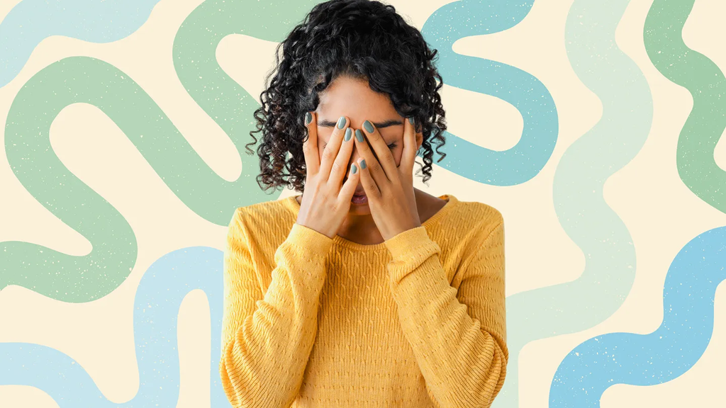 Anxious woman covering her face with her hands