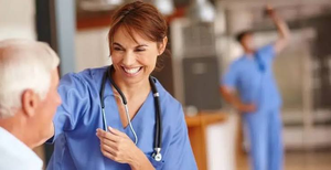 Smiling nurse with a stethoscope caring for a patient